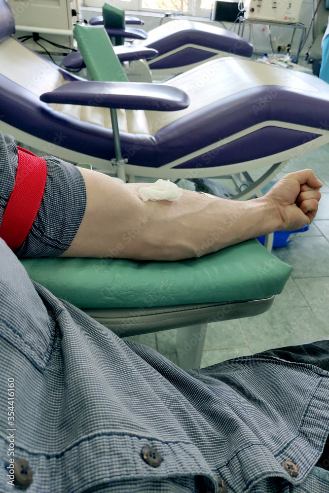 hand of a male blood donor during the procedure hand of a male blood donor during the procedure