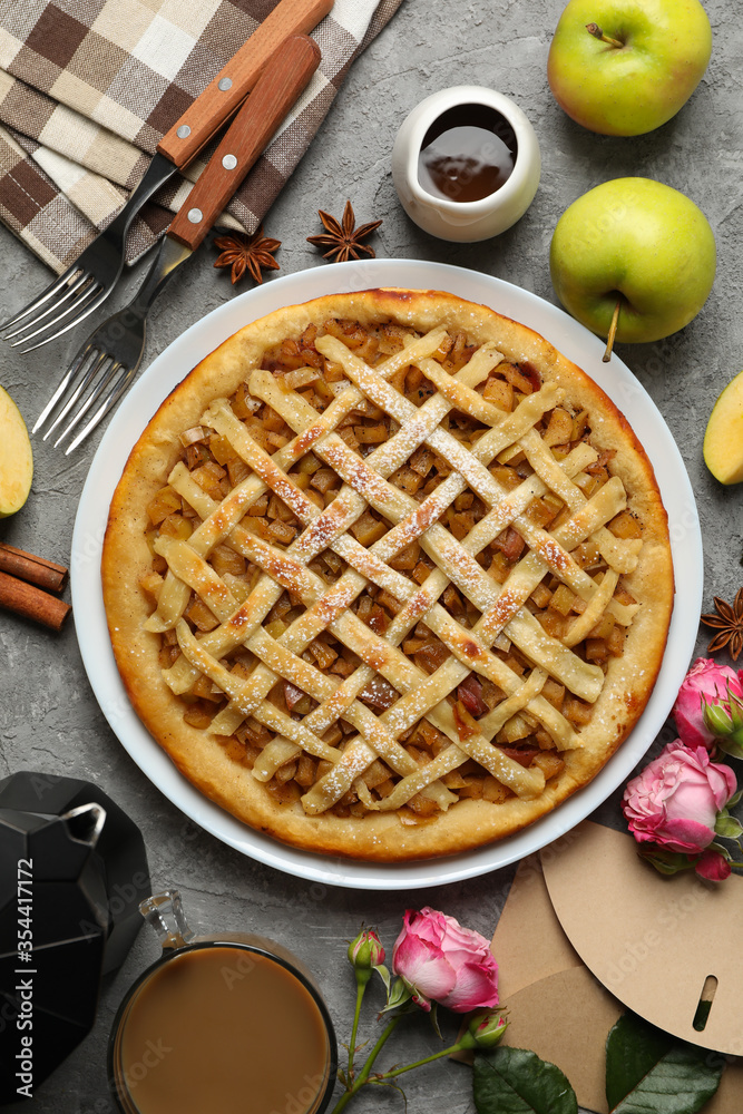 Composition with apple pie and ingredients on gray background, top view Composition with apple pie and ingredients on gray background, top view
