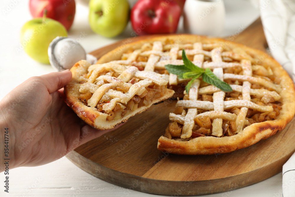 Female hand holding piece of apple pie. Homemade food Female hand holding piece of apple pie. Homemade food