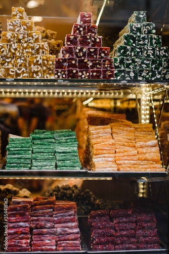 turkish delight famous turkey sweets candies baklava dessert in windows outlet in wonderful lighting on istiklal caddesi street at night in istanbul turkey 14/05/2018. Photography of beautiful sweets