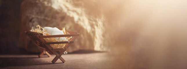 Wooden manger and star of Bethlehem in cave, nativity scene background. Christian Christmas concept. Birth of Jesus Christ. Jesus is reason for season. Salvation, Messiah, Emmanuel, God with us, hope