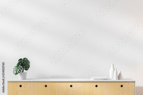 Foto Wooden shelf with a potted plant and decorative bottles on a white wall background