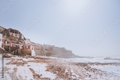 Scenic view of Fisherman's Village near Tiznit, Morocco. Traditional fishing cave dwellings and clifs. Paradise wild beach in Aglou photo
