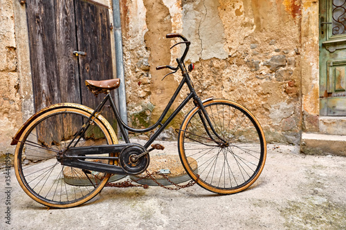 Old retro bicycle on vintage street in Croatia background aged wall and wooden door. City Lovran.