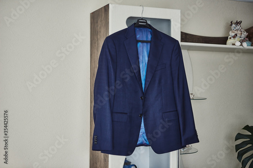 men's suit hanging in the room