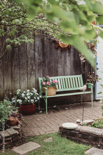 Bench in a garden with pink and white flowers
