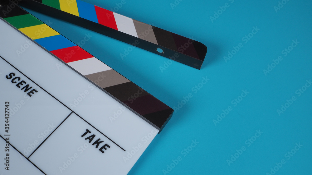 Clapperboard or movie slate on blue background.