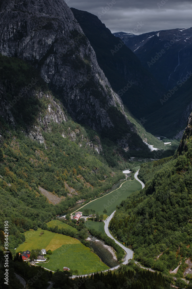 Vertical Norwegian landscape. The gorge where the small Northern village is located