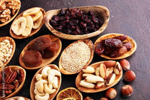 Composition with dried fruits and assorted healthy nuts in wooden bowls