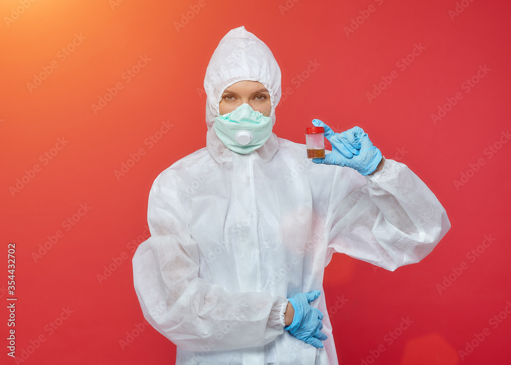 female doctor in a chemical suit. concept of medicine. red background female doctor in a chemical suit. concept of medicine. red background