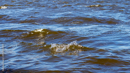 Waves on dark blue water. Windy cold weather