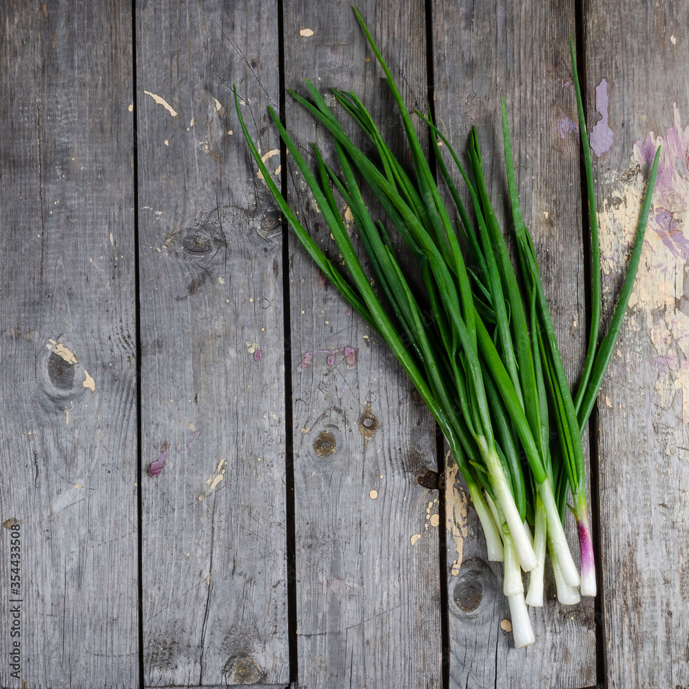 Pile of fresh spring onion on wood table Pile of fresh spring onion on wood table