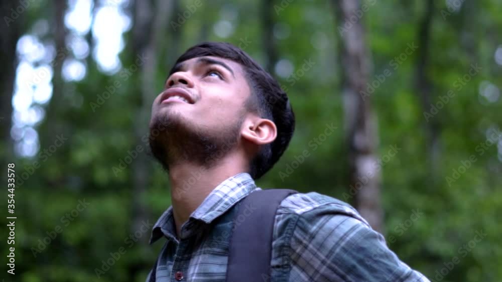 young indian man enjoying himself in the wild orbit shot trees forest hike trail young indian man enjoying himself in the wild orbit shot trees forest hike trail
