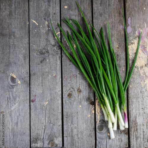 Pile of fresh spring onion on wood table