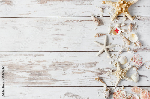 Sea starfish and shells on wooden background top view.