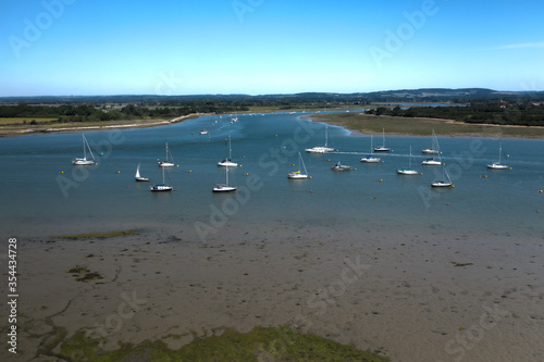 Aerial view of the estuary near Itchenor looking inland with the boats and yachts moored in the protected water.