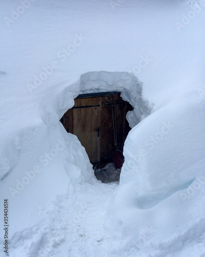 Door of snow covered mountain hut in the Austrian alps. © A. Emson