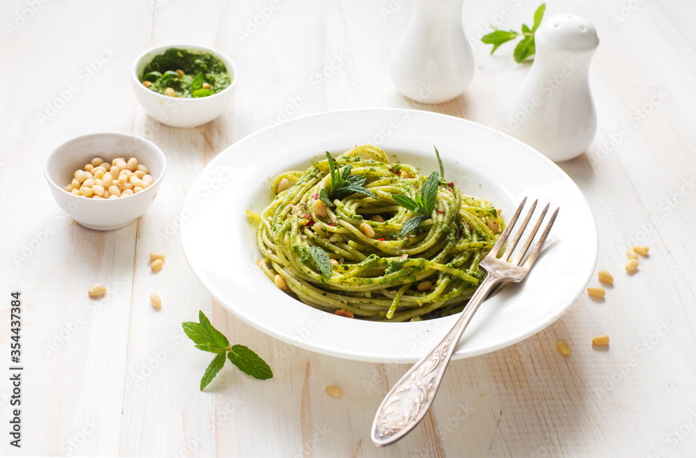 Italian pasta with basil and spinach pesto close up Italian pasta with basil and spinach pesto close up