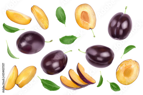 fresh purple plum and half with leaves isolated on white background with clipping path and copy spase for your text. Top view. Flat lay photo