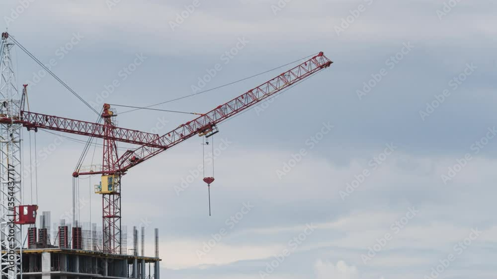 Time lapse view Modern building condominium under crane construction against cloudy sky Time lapse view Modern building condominium under crane construction against cloudy sky