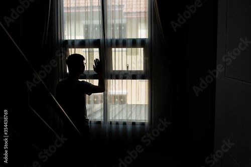 The shadow of a man standing in the house, People sad with depression concept.