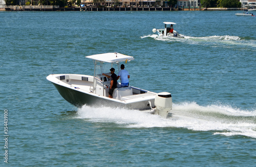 Open fishing boat with canopied center console on the Florida Intra-Coastal Waterway.