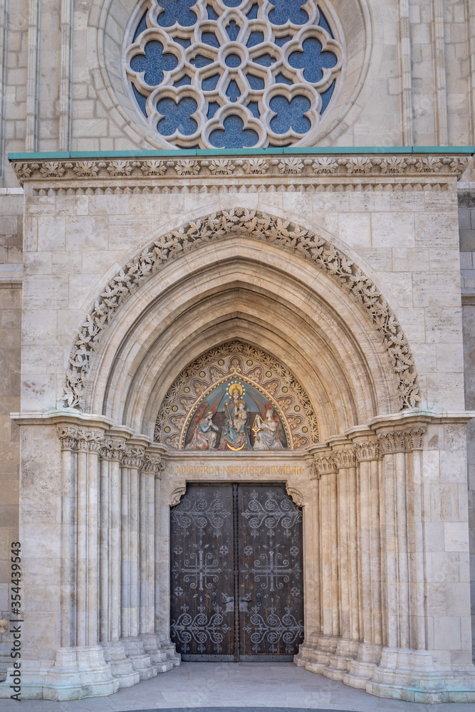 West side entrance of Matthias church with Mary the Lady of the Hungarians in Budapest