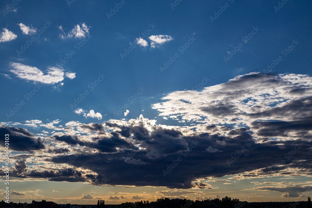 Beautiful clouds on a background of blue sky. Sunset sky.
