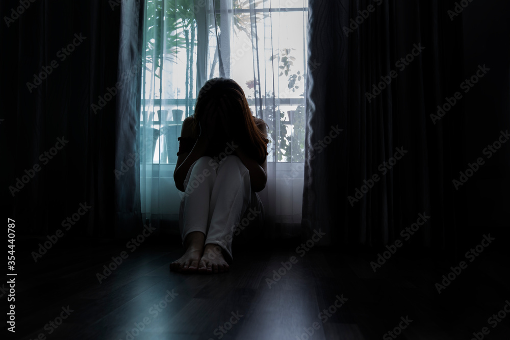 Sad young woman sitting on the bed in the bedroom, People with depression concept, people bad frustrated exhausted feeling down. 	