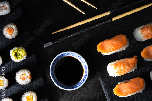 Healthy traditional japanese Sushi set nigiri and rolls with chopsticks.