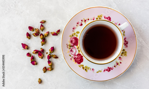 Top view of a cup of tea with dried roses