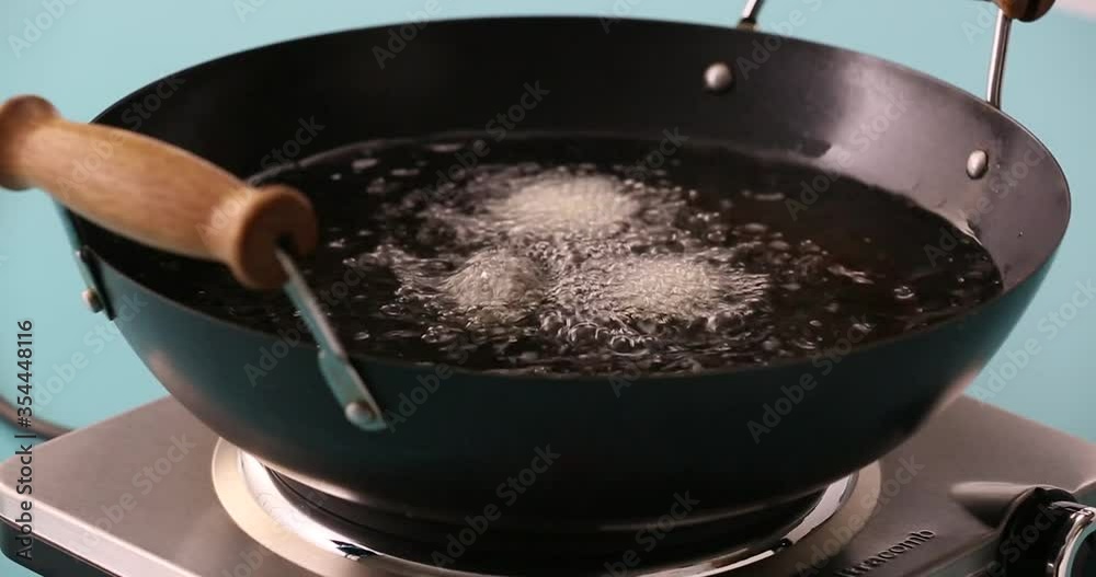 Cutting potatoes, covering in flour and putting potato fries in a collander adding garlic to oil placing and cooking french fries in the fryer, setting down a plate of fries Cutting potatoes, covering in flour and putting potato fries in a collander adding garlic to oil placing and cooking french fries in the fryer, setting down a plate of fries