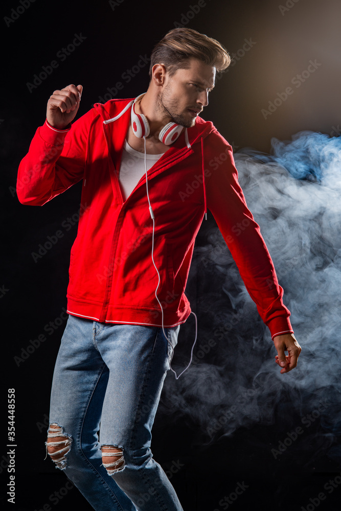 Strong man wear red hoodie over black background Stock Photo | Adobe Stock