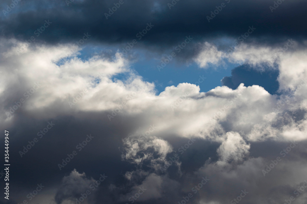 Detail of towering dramatic clouds in the Andean skies, stormy cloud formations laden with water about to precipitate, contrasted by the afternoon lights.