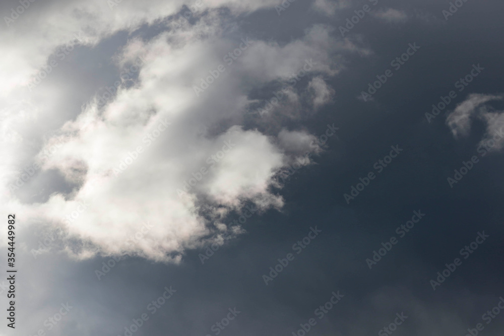 Detail of towering dramatic clouds in the Andean skies, stormy cloud formations laden with water about to precipitate, contrasted by the afternoon lights.