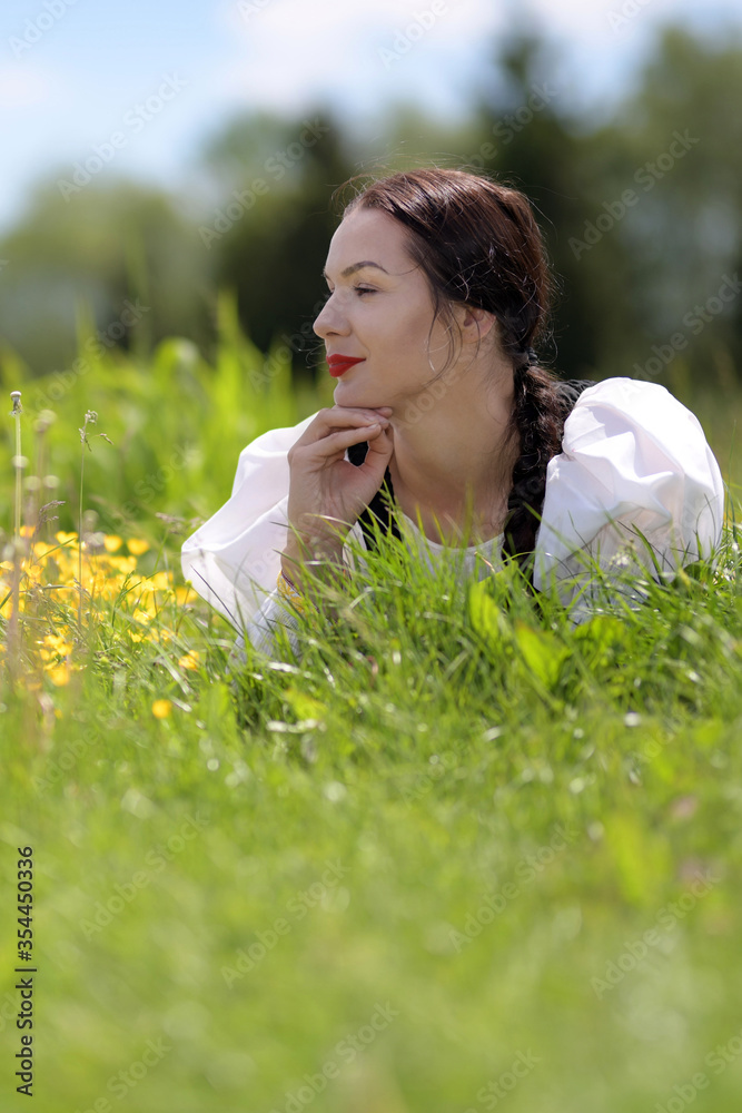 Young beautiful slovak woman in traditional costume on summer Young beautiful slovak woman in traditional costume on summer