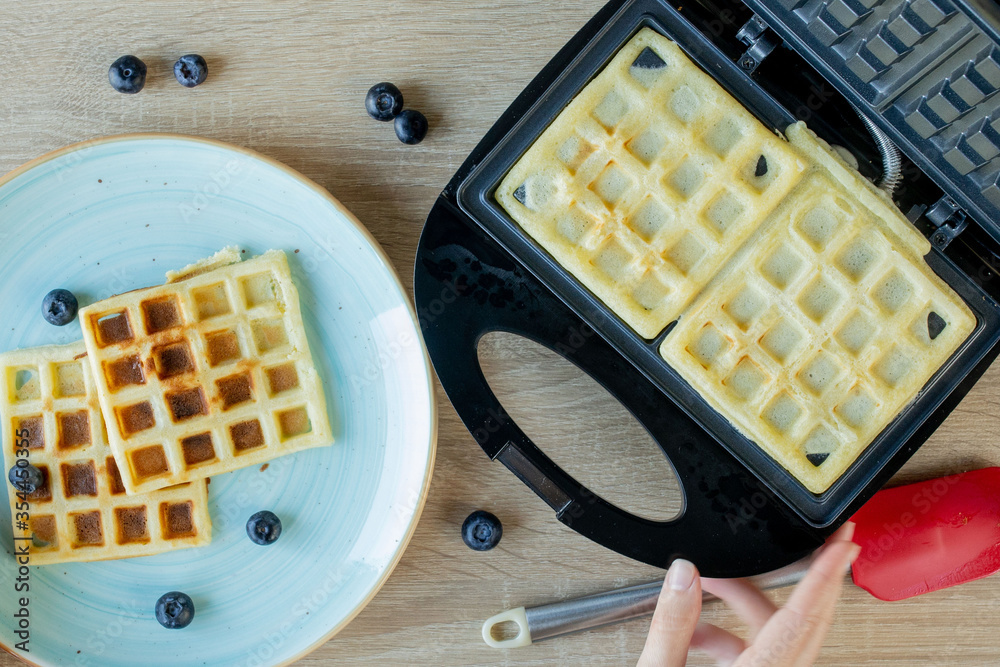Waffles Being Baked in the Waffle Maker. Savory waffles. Breakfast concept