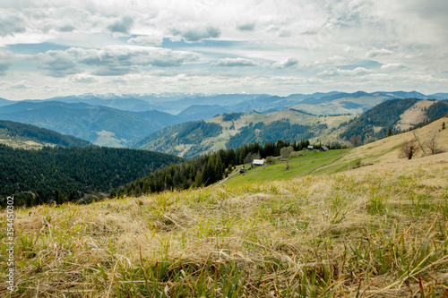 Carpathian Mountains top view landscape ridge summer season dramatic weather time with cloudy blue sky background