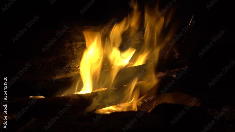 Bonfire close-up. Flames of fire in slow motion. Big tree trunks, logs are burning. Bonfire close-up. Flames of fire in slow motion. Big tree trunks, logs are burning.