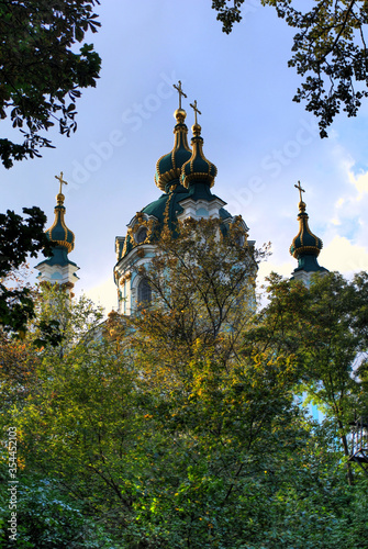 Fotografie Church with green-gold doom in Ukraine where river streams