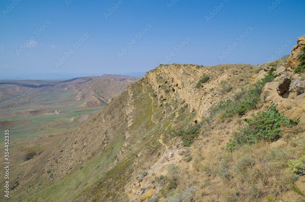 Cave monasteries. Path on the rock edge, on the half-desert slopes of Mount Gareja. David Gareja is a rock-hewn Georgian Orthodox monastery complex. Kakheti region, on border of Georgia and Azerbaijan