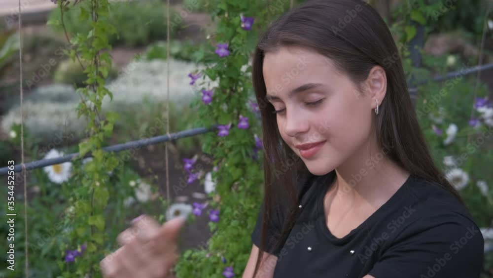 Teen in flowers garden. Portrait of a beautiful girl in a blooming garden. Teen in flowers garden. Portrait of a beautiful girl in a blooming garden.