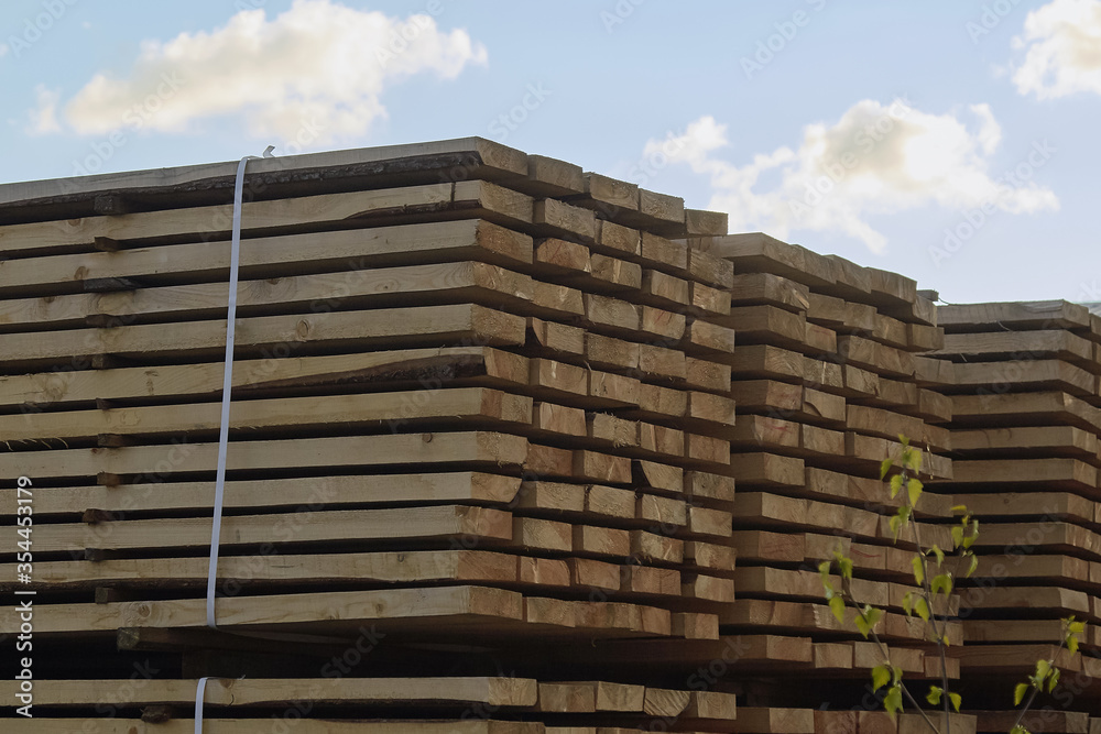 Pallet storage of wood in the company in the industrial zone of the city on a spring day Pallet storage of wood in the company in the industrial zone of the city on a spring day