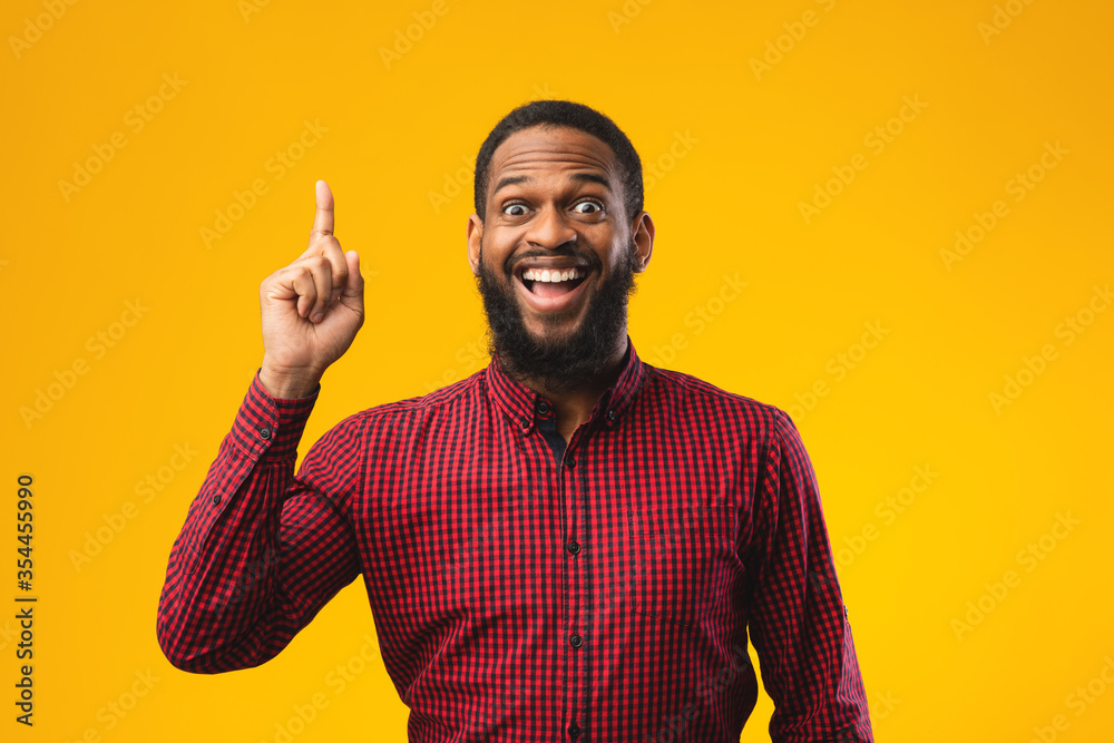 Excited black guy has great idea and points up Excited black guy has great idea and points up