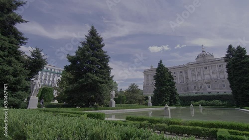 Madrid city centre panning shot across park and civic buildings with lake in foreground photo