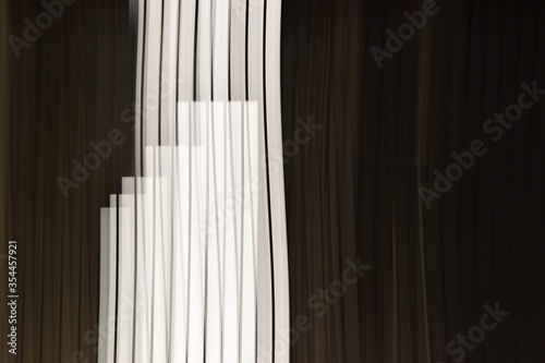 Abstract black and white vertical stripes. Bright lights at night.