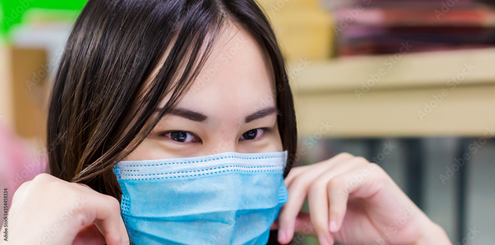 Asian woman wearing a face mask that protects against the spread of coronavirus disease Covid-19. Close up of annoyed red blood eyes woman affected by conjunctivitis or after flu, cold or allergy. Asian woman wearing a face mask that protects against the spread of coronavirus disease Covid-19. Close up of annoyed red blood eyes woman affected by conjunctivitis or after flu, cold or allergy.