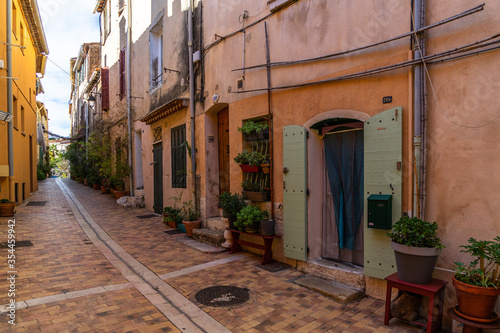 A colorful pedestrian alleyway in the picturesque resort town of Cassis in  Southern France