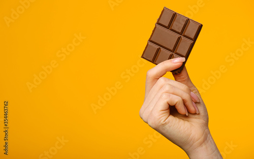 Closeup shot of milk chocolate in female hand