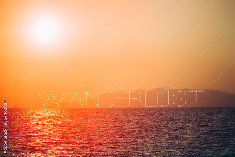 Fototapeta premium Amazing sunset on a seascape, with the word wanderlust text on layer,